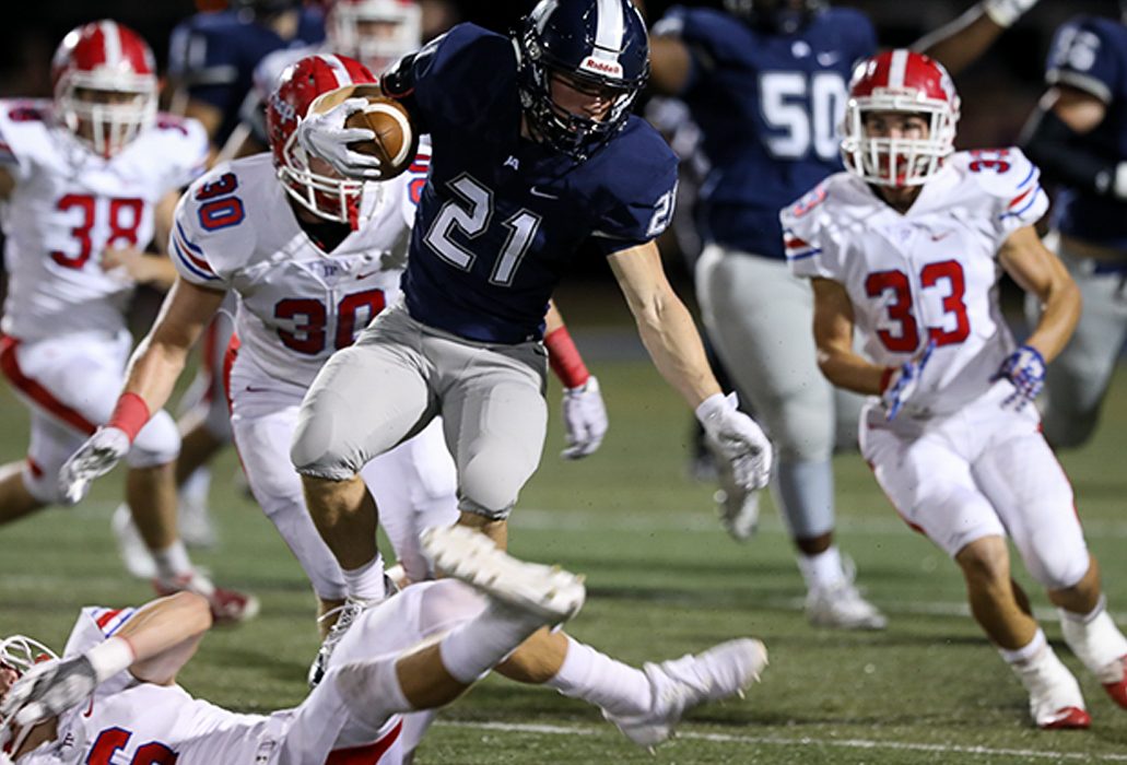 Raider Field comes alive as a JA running back evades defensive players and heads quickly toward the end zone.